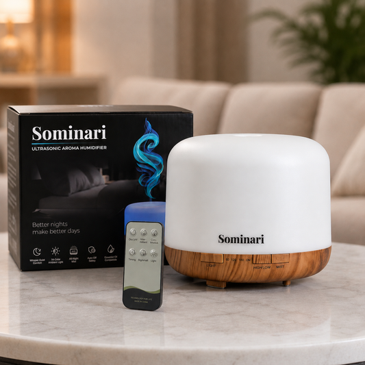 Sominari ultrasonic aroma humidificador with a white dome and a wooden base, shown next to its black retail box and a gray remote control on a marble table in a living room setting.